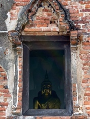 Un Bouddha aperçu par une fenêtre attire notre attention, allons voir de plus près. Wat Samanakottaram, Ayutthaya, Thailande.
